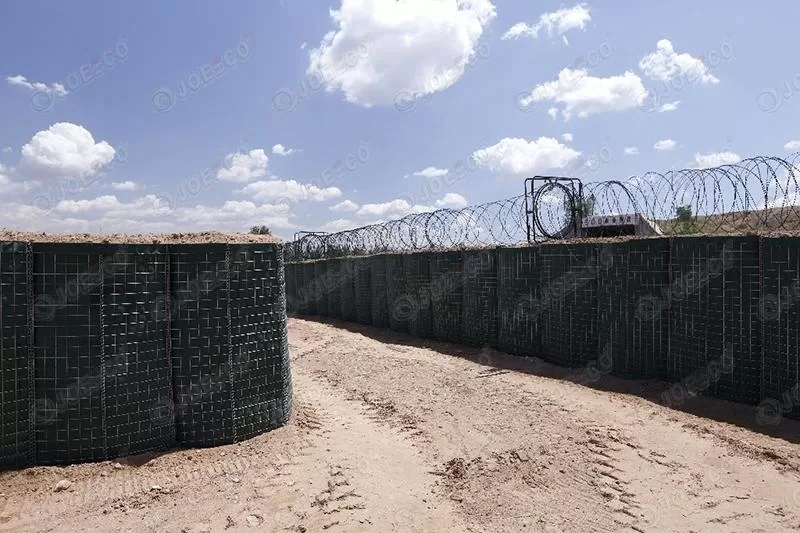 trenches on the ground built by hesco barrier