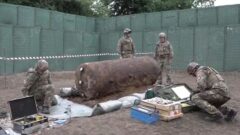 NATO forces, protected by JOESCO hesco barriers, cleared unexploded bombs from WWII