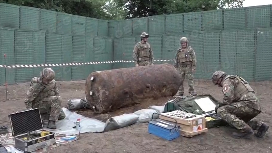 NATO forces, protected by JOESCO hesco barriers, cleared unexploded bombs from WWII